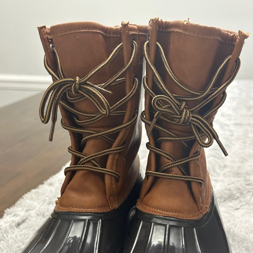 The Original Duck Boots, size 8m and the color is medium brown.